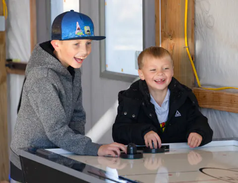 Air hockey in the clubhouse game room at Lake Hudson Resort